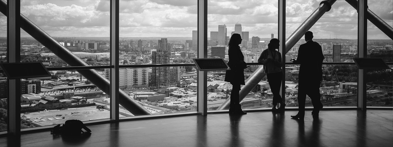 People standing at window in corporate building