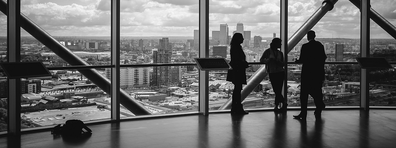 People standing at window in corporate building