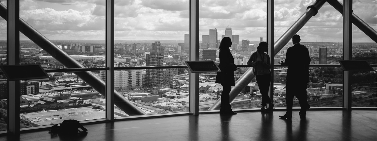 People standing at window in corporate building