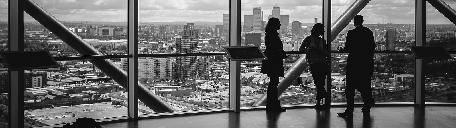 People standing at window in corporate building