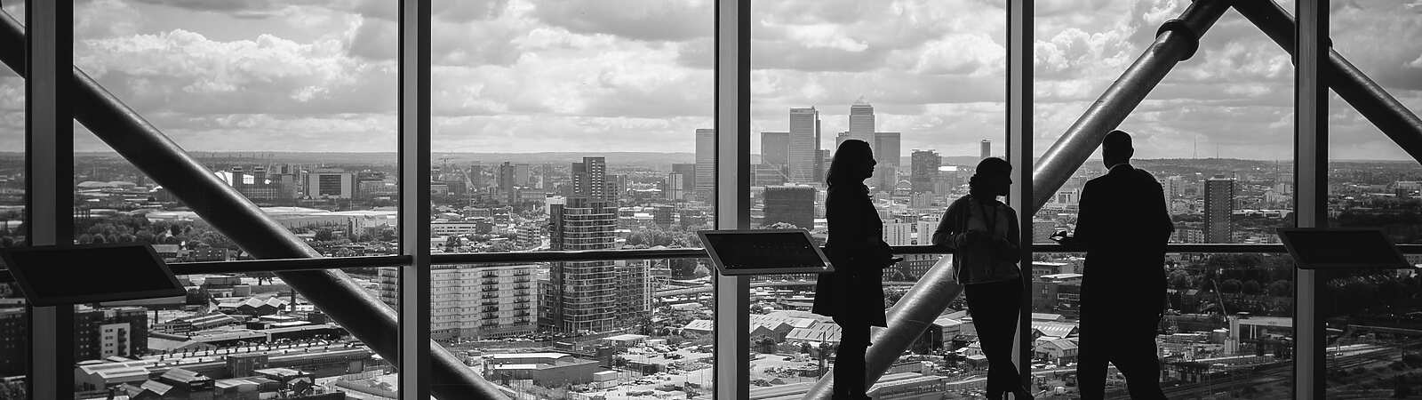 People standing at window in corporate building