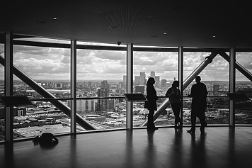People standing at window in corporate building