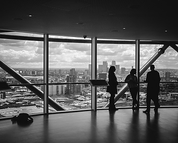People standing at window in corporate building