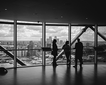 People standing at window in corporate building
