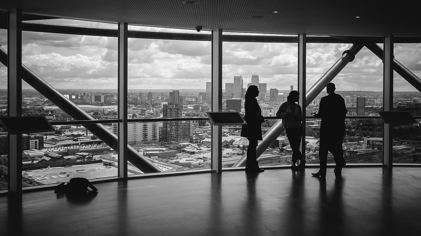 People standing at window in corporate building