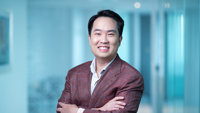 a person in a suit with his arms crossed
