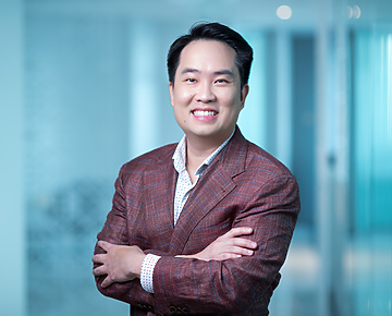 a person in a suit with his arms crossed