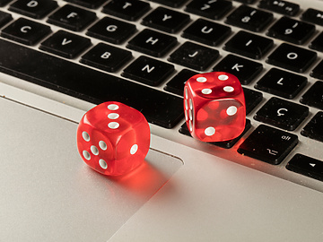 games dice sitting on laptop