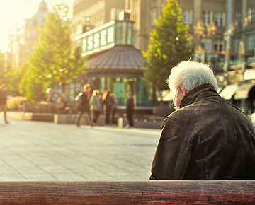 a person sitting on a bench in a city