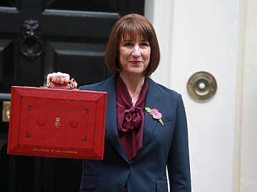 Woman holding red briefcase outside 10 Downing Street