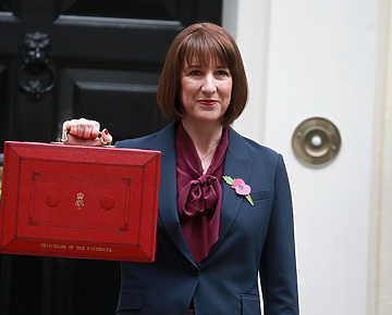 Woman holding red briefcase outside 10 Downing Street