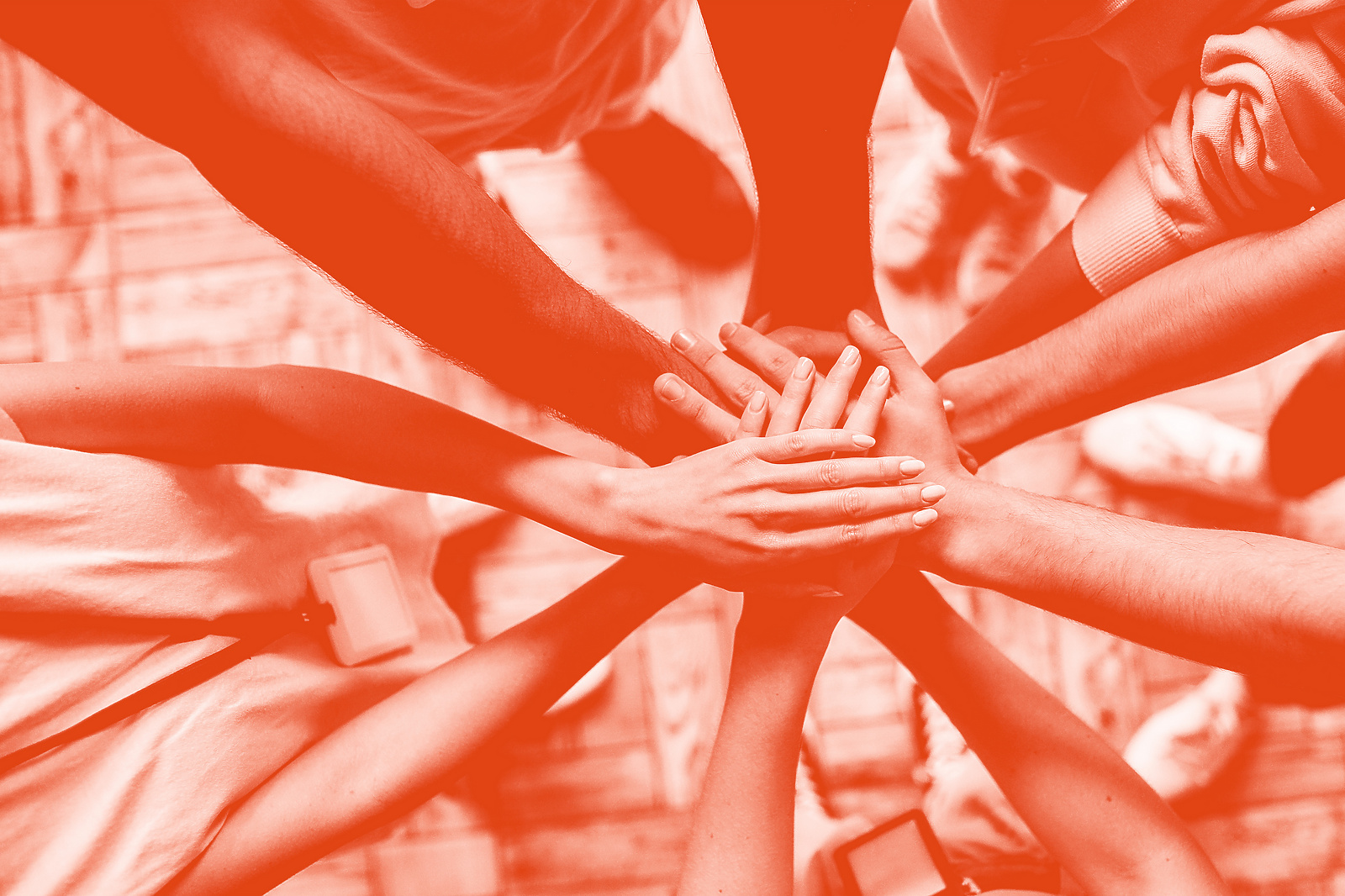 a group of people putting their hands together