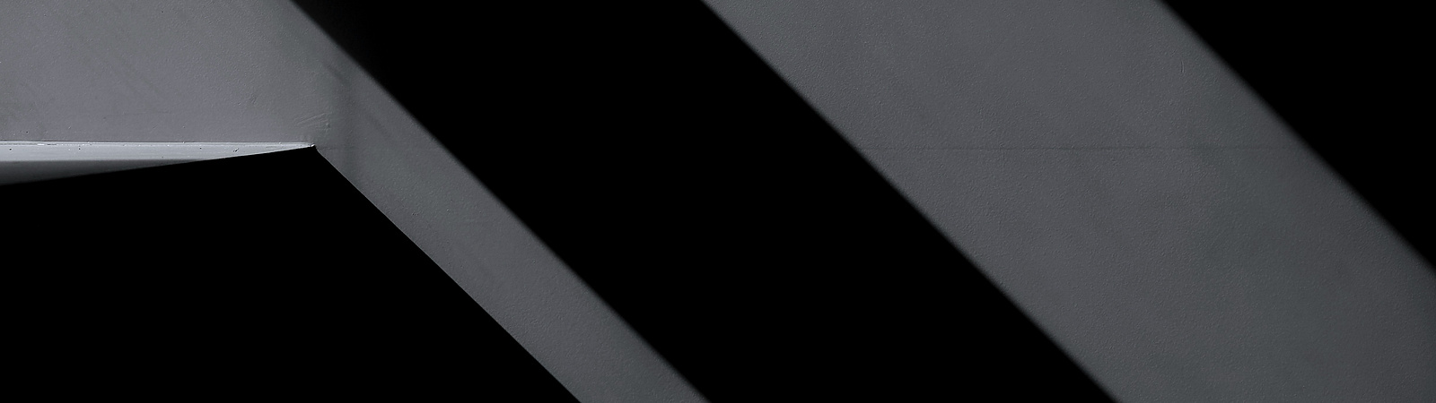 a close up of a metal beam on a black background