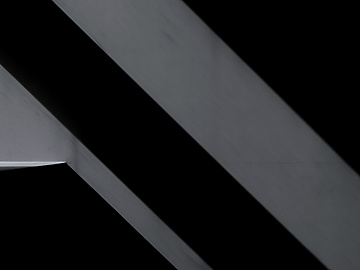 a close up of a metal beam on a black background