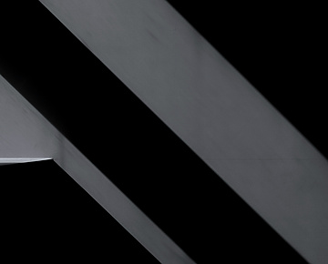 a close up of a metal beam on a black background