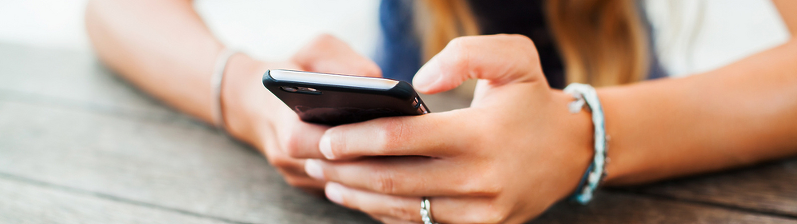 Woman sitting down on her phone
