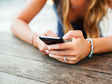 Woman sitting down on her phone