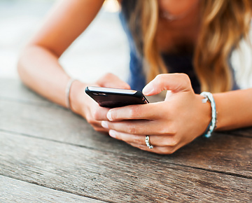Woman sitting down on her phone