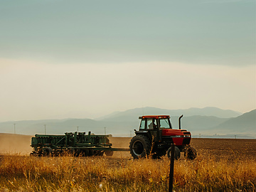 tractor harvesting field