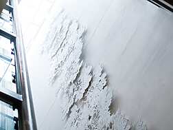 a white wall with trees on it