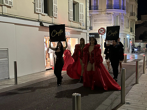 a group of people in holding signs in the street