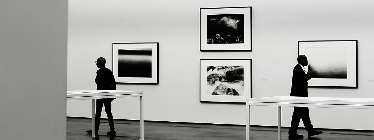 people looking at a piece of art