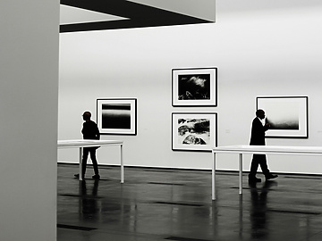 people looking at a piece of art