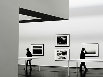 people looking at a piece of art