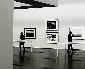 people looking at a piece of art