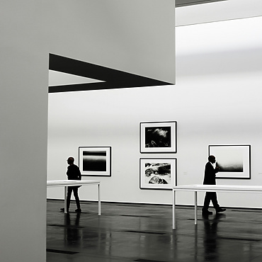 people looking at a piece of art