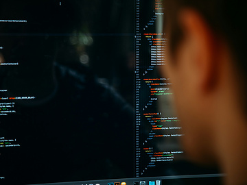 Person looking at screen of code