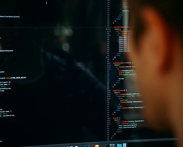 Person looking at screen of code