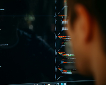 Person looking at screen of code