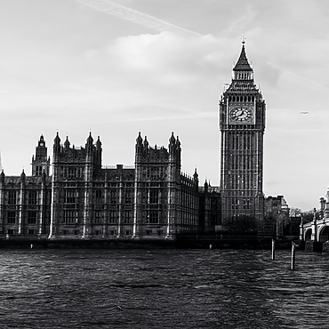 a clock tower next to a bridge
