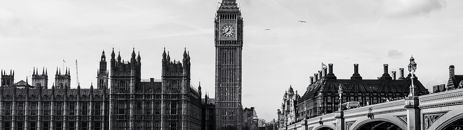 a clock tower next to a bridge