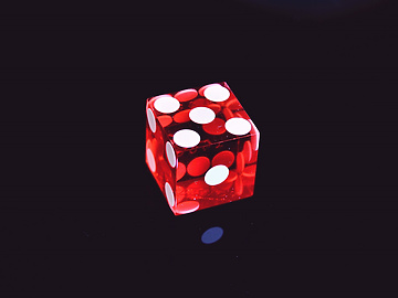 a red dice with white dots