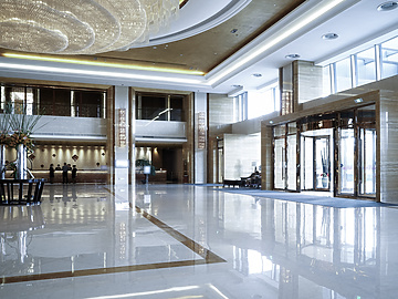 a large hall with glass doors and a chandelier