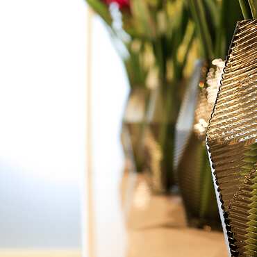 a group of vases with flowers
