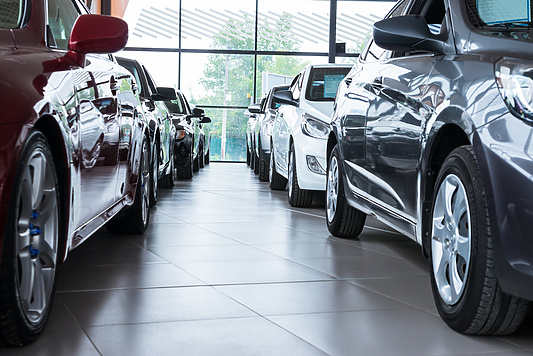 a row of cars in a showroom