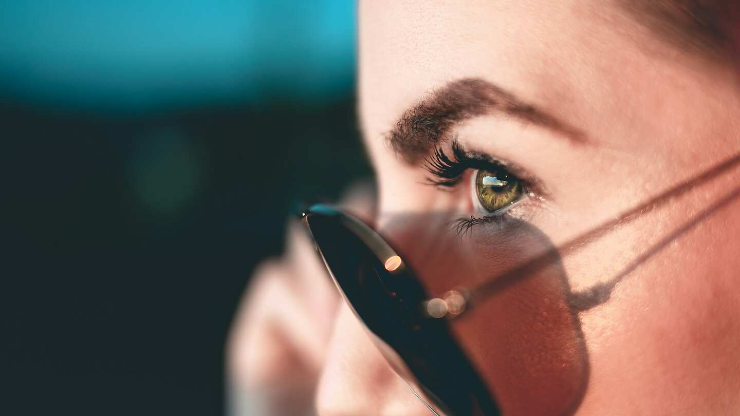 A lady looking through sunglasses