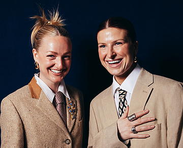 a couple of women in suits