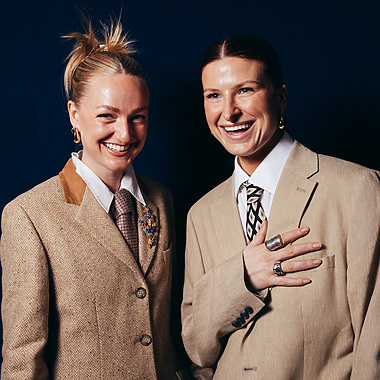 a couple of women in suits
