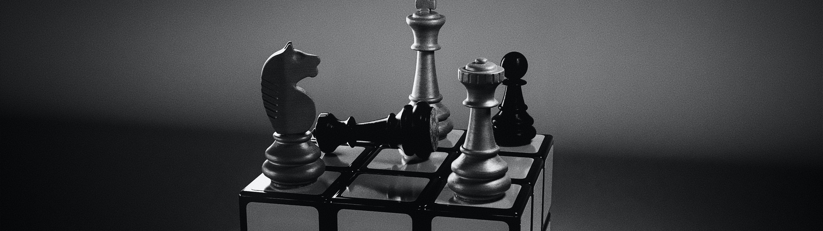 a rubics cube with chess pieces on top