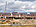 a construction site with a crane and buildings