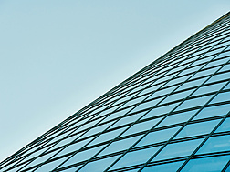 a glass building with blue sky