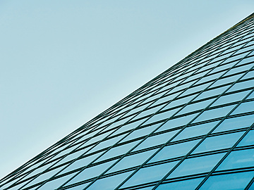 a glass building with blue sky