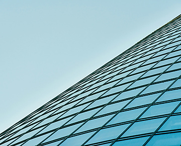 a glass building with blue sky