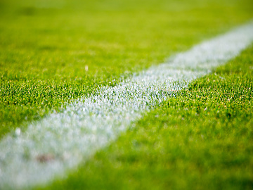 synthetic green grass and crisp white lines of a football field