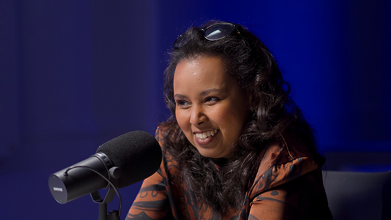 a person sitting at a microphone