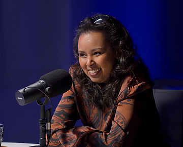 a person sitting at a microphone